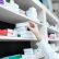 closeup-view-pharmacist-hand-taking-medicine-box-from-shelf-drug-store (1) obat sakit gigi di apotek